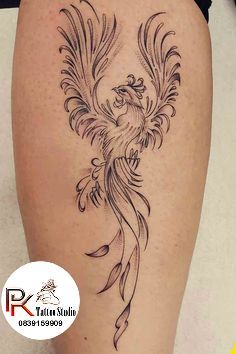 a woman's thigh with a bird tattoo on it