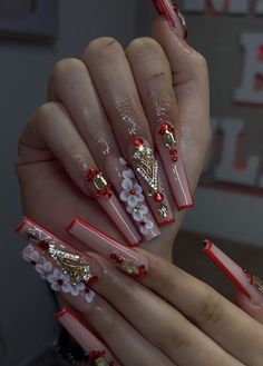 Red Nails For Xv, Red Acrylic Nails 3d Flowers, Red Acrylic Nails For Quince, Xv Nails Red, Red And Gold Acrylic Nails For Quince, Quince Nails Red And Gold Long, Red And Gold Quinceanera Theme Nails, Red Long Nails With Rhinestones, Nails For Quinceanera Red