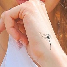 a woman with a small tattoo on her wrist