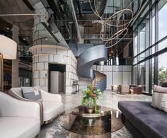 a living room filled with furniture and a spiral staircase