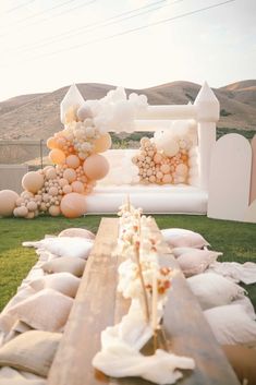 a long table with pillows and balloons on it