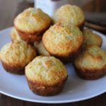 a white plate topped with muffins on top of a wooden table