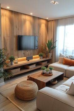 a living room filled with furniture and a flat screen tv mounted on a wall above it