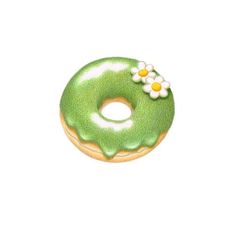 a donut with green icing and daisies on it's top, sitting in front of the words matcha donut