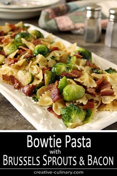 a plate with pasta, bacon and brussels sprouts