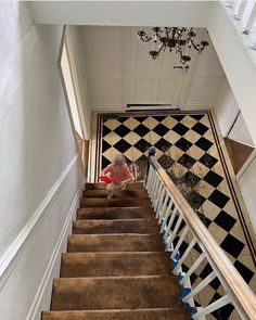 a stair case with black and white tiles on it