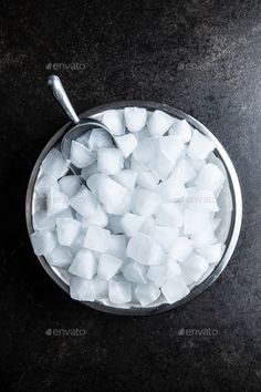 sugar cubes in a metal bowl on a black surface - stock photo - images