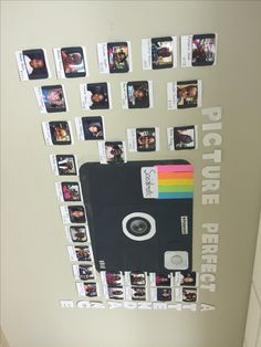 an old polaroid camera is hanging on the wall with photos attached to it's sides