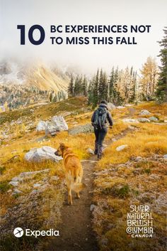 a man walking down a trail next to a dog