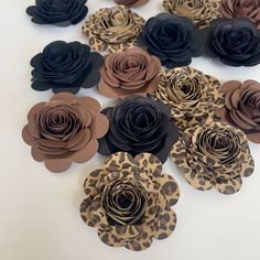 the paper flowers are made from leopard print and have black, brown, and tan colors