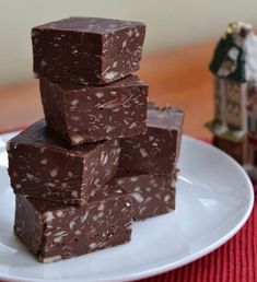 a stack of chocolate fudges sitting on top of a white plate