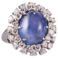 Impressive 18k gold ring with center oval cabochon sapphire - approx. 15.20ct (stone measures 14.8 x 11.6 x 8.2mm), surrounded with approx. 2.00ctw SI1/H diamonds. Ring size 5, top is 24mm x 21mm. Tested 18k, not marked. Weight 15.8 grams. Luxury Cabochon Sapphire Ring, Luxury Oval Cabochon Engagement Ring, Luxury Solitaire Oval Cabochon Jewelry, Luxury Yellow Gold Sapphire Ring With Oval Cabochon, Sapphire Cabochon, Jewelry Holders, Diamonds Ring, 18k Gold Ring, Oval Cabochon