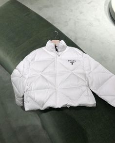 This Prada Shell Jacket part of their ski wear collection has proved to be an instant hit. All items are brand new & 100% authentic guaranteed. DETAILSWhiteBlack logo print on the leftExterior and lining 100% polyamide excluding resin coating in synthetic material; filler bag 100% recycled polyester; padding 90% white goose down, 10% white goose feathersZip fasteningCropped fit, goose down padding, stand-up collar, long sleeves, elasticised cuffs, zipper pockets, elasticised drawstring hem, diamond-motif stitching, internal patch pockets plus double welt pocket with zipperMade in Italy Can't find your size? Use our Sourcery service or speak to a member of our team via WhatsApp Prada Aesthetic, Prada Coat, Prada Jacket, White Goose, Prada Logo, Resin Coating, Chic Handbags, Timeless Handbag, White Jacket