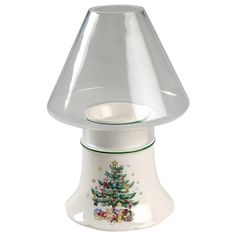 a glass lamp with a christmas tree on it