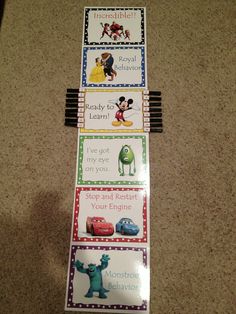 four disney themed bookmarks on the floor