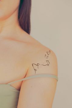 a woman with a tattoo on her shoulder