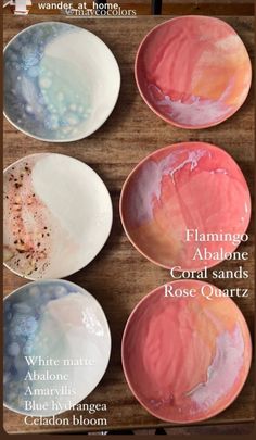 four plates with different colors on them sitting on a wooden table in front of the words flamingo abano coral sands rose quartz