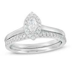 a wedding ring set with a pear shaped diamond in the center and side stones on each band