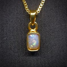 "Elevate your jewelry collection with this exquisite handmade rectangle opal necklace from The Opal Source. The pendant features a beautiful white opal set in a flawless yellow gold filled bezel. Type - White Location - Coober Pedy Weight - 0.60 cts Size - 6mm x 4mm x 3mm Pattern - Floral Shape - Rectangle Metal - 18k Gold Filled Chain - 18\" 1mm Box Chain View a full video of this beautiful necklace - https://www.theopalsource.com/product-page/colorpainted-australian-coober-pedy-handmade-rectan Coober Pedy, Mens Accessories Jewelry, Beautiful Necklace, Opal Necklace, White Opal, Pattern Floral, Product Page, Gold Filled Chain, Box Chain