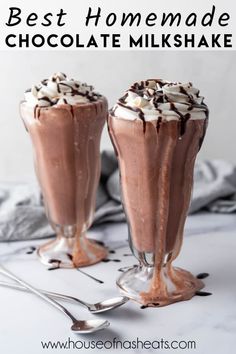 two glasses filled with chocolate milkshake and topped with whipped cream