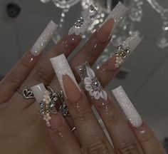 a woman's hand with some white and silver nails