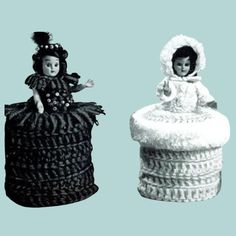 there are two dolls sitting on top of the same basket and one is wearing a dress