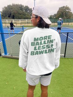 Spread the pickleball love with this fun pickleball crewneck! Let everyone know you're a pickleball aficionado with the 'More Ballin' Less Bawlin'' front and back design. Perfect for rec play, tournament, off the court or anywhere you want to add some pickle-y flair! 🥒 UNISEX SIZING * 50% cotton, 50% polyester * Pre-shrunk * Classic fit * 1x1 athletic rib knit collar with spandex * Air-jet spun yarn with a soft feel * Double-needle stitched collar, shoulders, armholes, cuffs, and hem PRINTING + Printed with DTG - Direct to Garment Printing - which is different than vinyl heat press. With DTG, the image is transferred directly onto the fabric, which will give it a worn-in look. This makes the shirt less stiff than a traditional vinyl transfer and easy to care for. SHIPPING + Our shipping p Oversized Pullover, Vinyl Transfer, Softest Sweater, Sports Theme, Fall Sweaters, Pickleball, Rib Knit, Long Sleeve Tops, Tops Designs