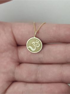 WE SHIP YOUR PARCEL IN ONE DAY! (Processing time - 1 Day, Estimated Delivery once Shipped - 3-5 business days) Engraved Om Design Necklace - Om Pendant Necklace - Handmade Om Gold Jewelry - Engraved Om Gold Necklace Engraved Om Pendant Necklace made out of 14K Solid Gold. Available in Yellow Gold, White Gold, or Rose Gold finish. An elegant piece of jewelry that is a perfect gift to yourself and your loved ones. Add your engraved personalization at the back of the pendant. Contact us with a clea Spiritual 14k Gold Jewelry Stamped 14k, 14k Gold Medallion Jewelry For Good Luck, Spiritual 14k Gold Round Pendant Jewelry, Spiritual 14k Gold Round Pendant, 14k Gold Spiritual Round Pendant Jewelry, Spiritual Hallmarked 14k Gold Jewelry, Gold Round Charm Necklaces For Good Luck, Spiritual 14k Gold Charm Necklace With Round Pendant, 14k Gold Spiritual Pendant Charm Necklace