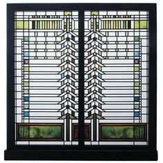 a stained glass window with an abstract design on the front and side panels, in black frame