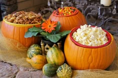 three pumpkins and two gourds filled with food