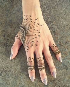 a woman's hand with tattoos on it