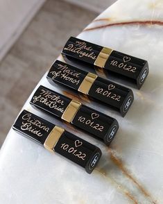 four black and gold batteries with writing on them