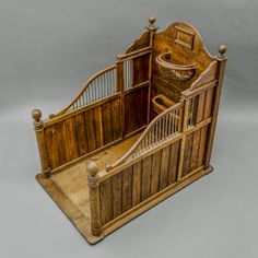 an old wooden baby crib with stairs and railings