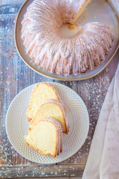 a bundt cake on a plate next to another bundt cake with one slice cut out