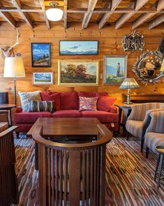 a living room filled with furniture and pictures on the wall