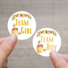 two round stickers with the words team girl and a jar of jam on them