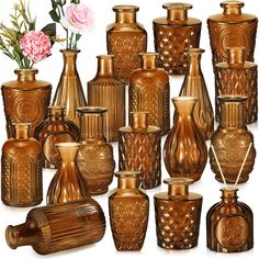 an assortment of vases and jars with flowers in them