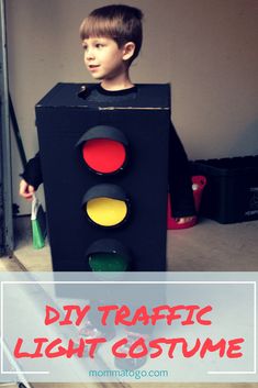 a young boy standing next to a traffic light with the words diy traffic light costume