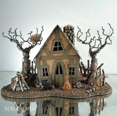 a house made out of wood and rocks with trees around it on a reflective surface