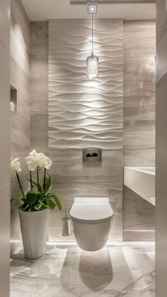 Modern powder room with a 3D textured wall marble flooring floating toilet and orchid decor creating an elegant and sophisticated space Trendy Small Bathroom Ideas, Luxury Powder Room, Guest Bathroom Design, Bathroom Decor Luxury, Bathroom Redesign, Bathroom Design Decor