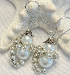 "These unique earrings are made with faux pearls, an antique silver bead cap and silver seed beads to form these cute snowmen. They measure approx. 1 3/4\" from the ear wires. Matching bracelet is available!" Silver Beaded Pearl Drop Earrings As Gift, Silver Pearl Beaded Earrings For Party, Handmade Silver Earrings For Holiday, Silver Pearl Beaded Earrings With Round Beads, Silver Pearl Drop Beaded Earrings, Elegant Beaded Earrings For Holiday, Handmade Silver Pearl Beaded Earrings, Silver Pearl Beaded Drop Earrings, Silver Beaded Earrings With Pearl Drop