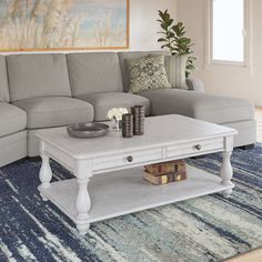 a living room with a couch, coffee table and rug