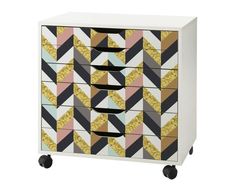 a multicolored chest of drawers with wheels on the bottom and gold foiling