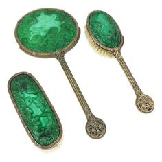 three antique hairbrushes with green glass in the shape of spoons and mirrors