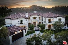 this is an aerial view of a home in the hills at sunset or sunrise time