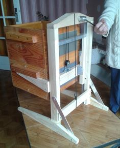 a person standing next to a wooden box