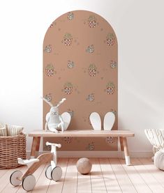 a wooden bench sitting in the middle of a room next to a wall with an arched window