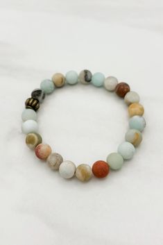 Discover the perfect balance of style and harmony with our Harmony Scallop Accent Multicolor Genuine Stone Beaded Stretch Bracelet. Made with high-quality genuine stones, this bracelet adds a touch of elegance to any outfit. Its stretch design ensures a comfortable and secure fit. Elevate your jewelry collection with this must-have accessory. Details:- Genuine Amazonite Stone Beads- Simple Design- One Size Fits Most Dimensions:- 2.25" resting Diameter- Can Stretch Up To 6"- 8MM Bead Size Yellow Agate, Amazonite Stone, Beaded Stretch Bracelet, Stretch Bracelet, Body Oil, Stretch Bracelets, Stone Beads, Simple Design, Simple Designs