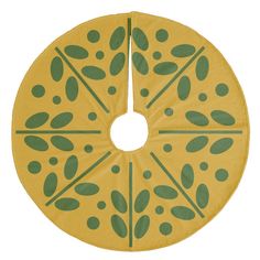 a yellow and green circular object with leaves on it