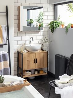 a bathroom with a sink, mirror and towel rack